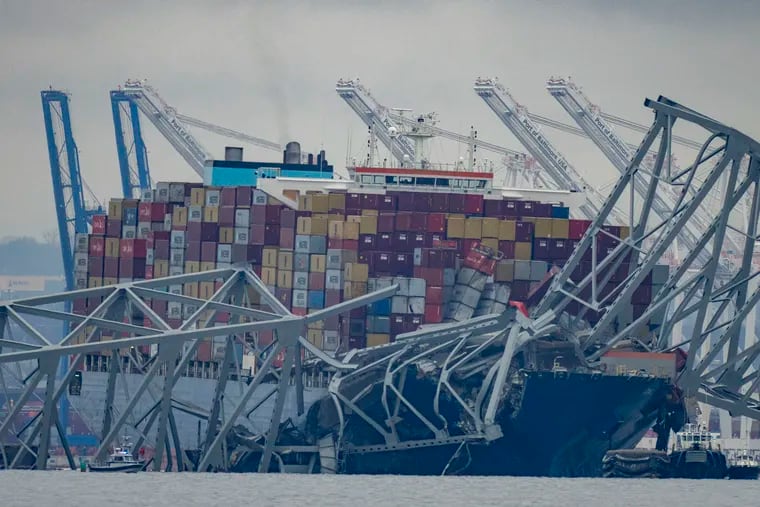 The container ship Dali, owned by Grace Ocean PTE, rests against wreckage of the Francis Scott Key Bridge in the Patapsco River on Wednesday as seen from Pasadena, Md.