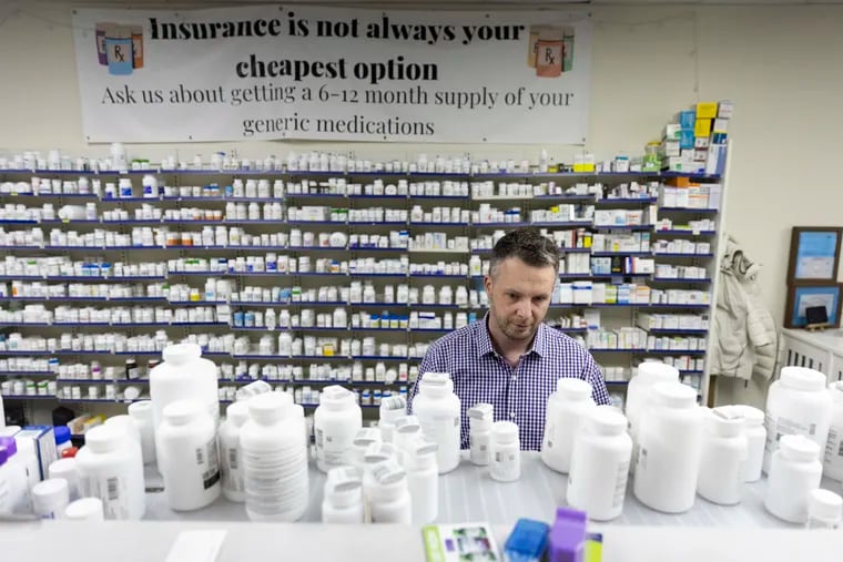 Dennis Czerw, owner of Parkway Pharmacy, counts pills in his pharmacy in Philadelphia, Pa., on Thursday, Feb. 1, 2024.