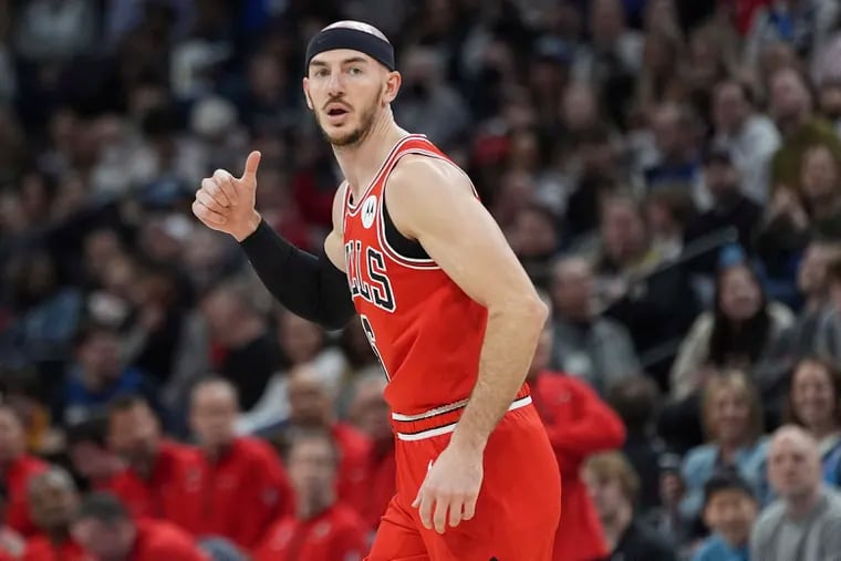 Chicago Bulls guard Alex Caruso gestures after making a 3-point shot during the first half of an NBA basketball game against the Minnesota Timberwolves, Sunday, March 31, 2024, in Minneapolis. (AP Photo/Abbie Parr)