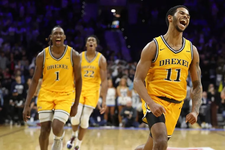 From left, Drexel's Lamar Oden Jr., Amari Williams, and Justin Moore celebrate after the 57-55 upset of Villanova on Dec. 2. All three Dragons are now in the transfer portal.