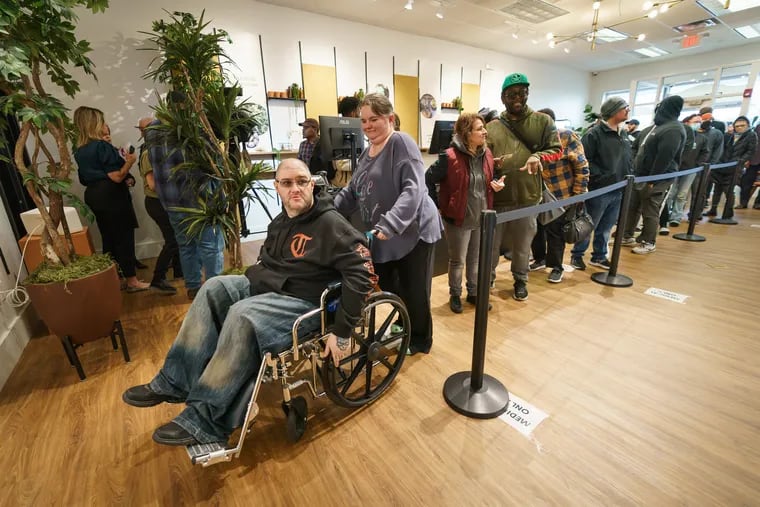 Richard Jester (left), who uses marijuana to help with the pain he experiences from spinal stenosis, and his fiancée, Diane Estlow (second from left), wait in line at The Botanist in Williamstown, on the first day of recreational cannabis sales in New Jersey, Thursday, April 21, 2022.