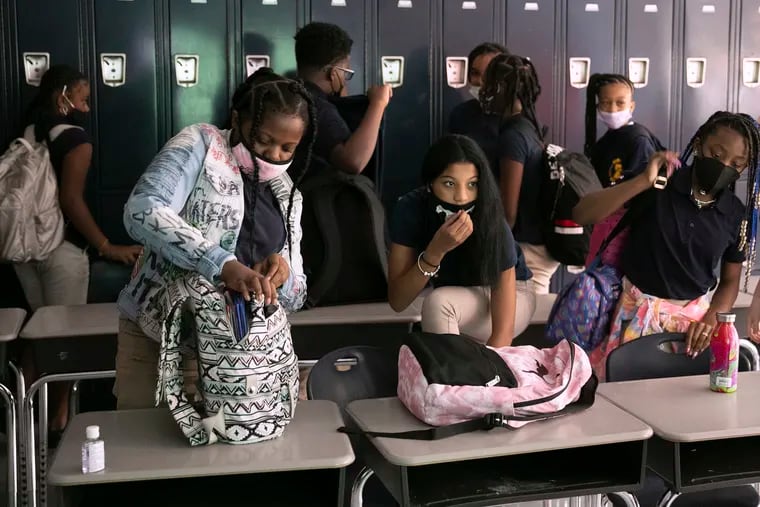 Seventh grade students Phoenix McGhee, Alyssa Vega, and Shakayla Johnson pack up their bags after social studies class on the first day of school at William H. Ziegler Elementary School on Tuesday, Aug. 31, 2021.