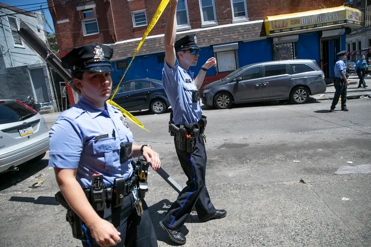 Philadelphia Police investigating a shooting in Kensington in May. The department has nearly 600 officer vacancies, and another 800 Police Department employees are expected to retire in the next four years.